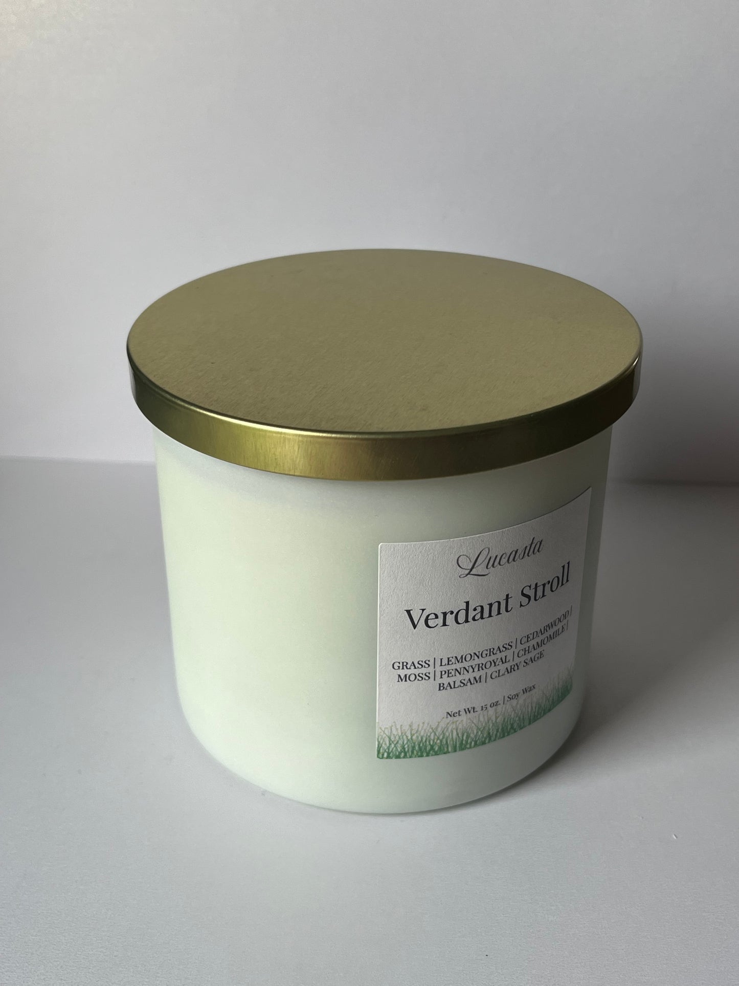 Round container with gold lid and label on a white background