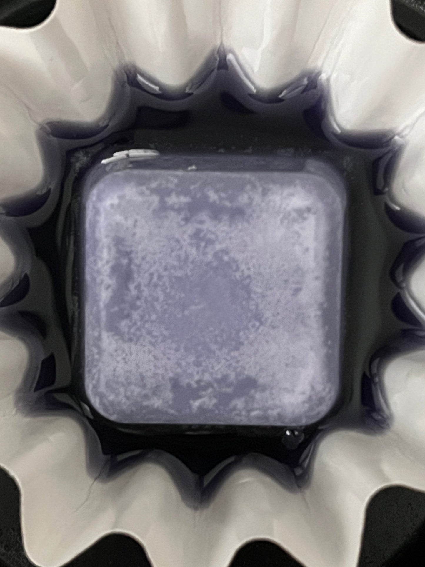 Close-up of a Lucasta Petal Whisper lavender wax melt melting in a warmer dish