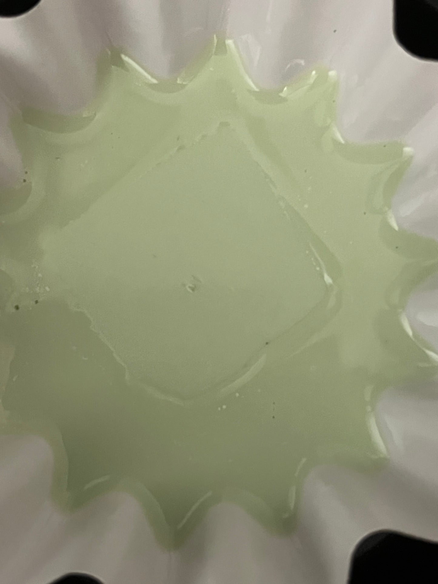 Close-up of Lucasta Verdant Stroll green wax melt melting in a warmer dish