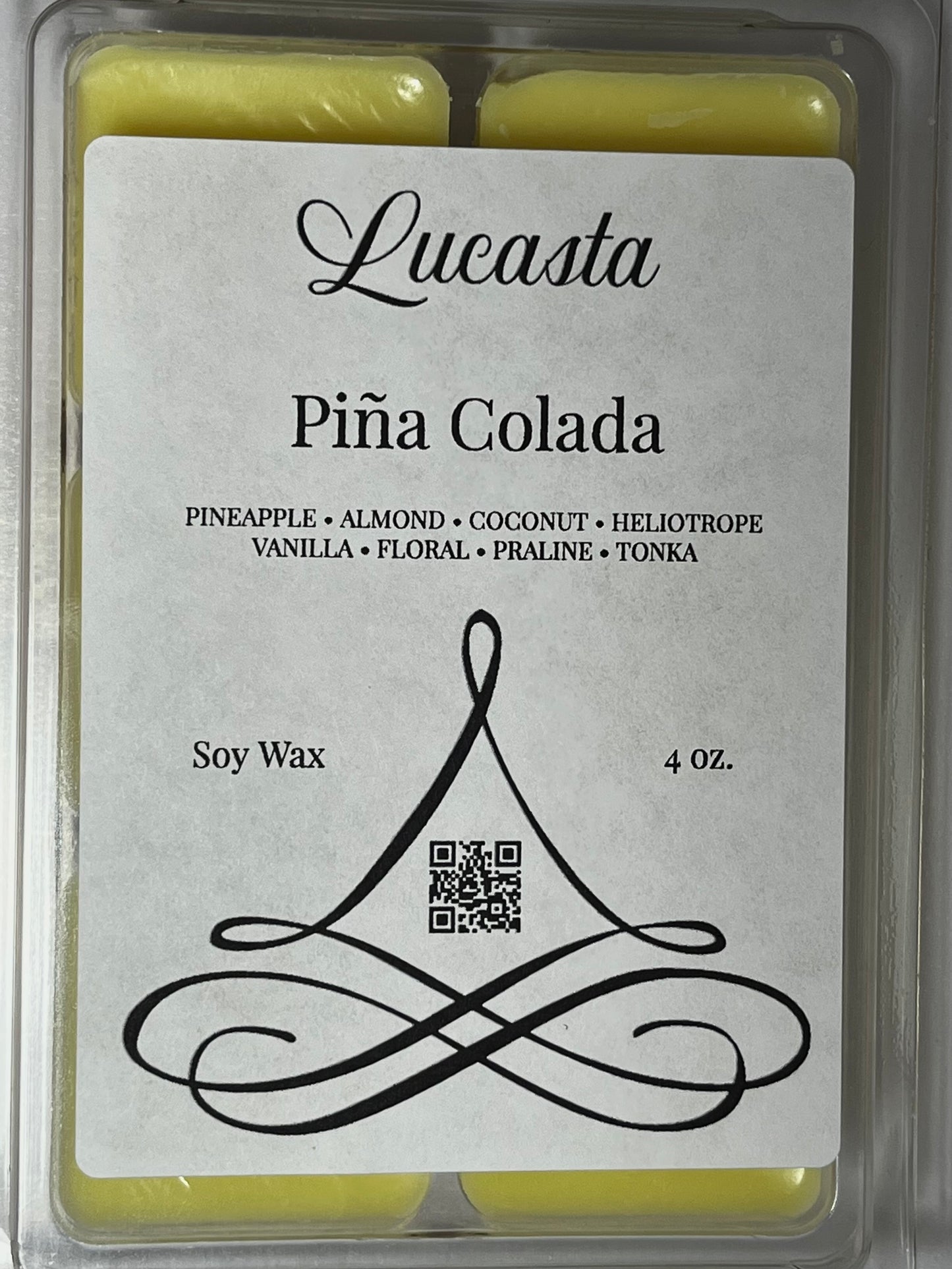 Close-up of Lucasta Piña Colada wax melt label showing scent notes pineapple, almond, coconut, heliotrope, vanilla, floral, praline, tonka, soy wax, 4 oz