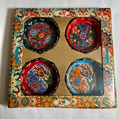 Set of four hand-painted Turkish ceramic ashtrays with colorful floral designs in original packaging