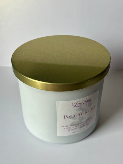 White candle jar with gold lid on a white background