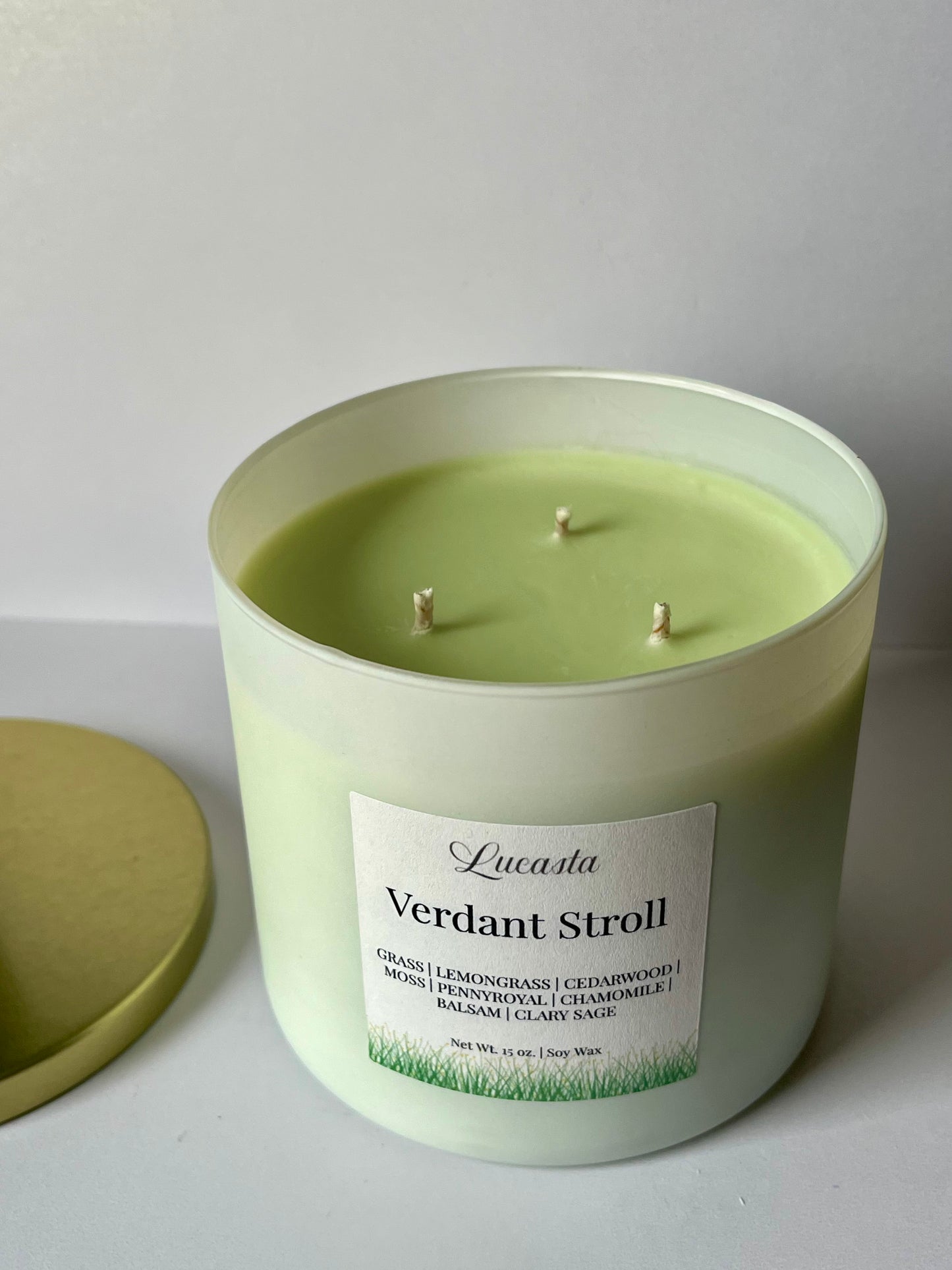 Green candle with 'Verdant Stroll' label on a white background