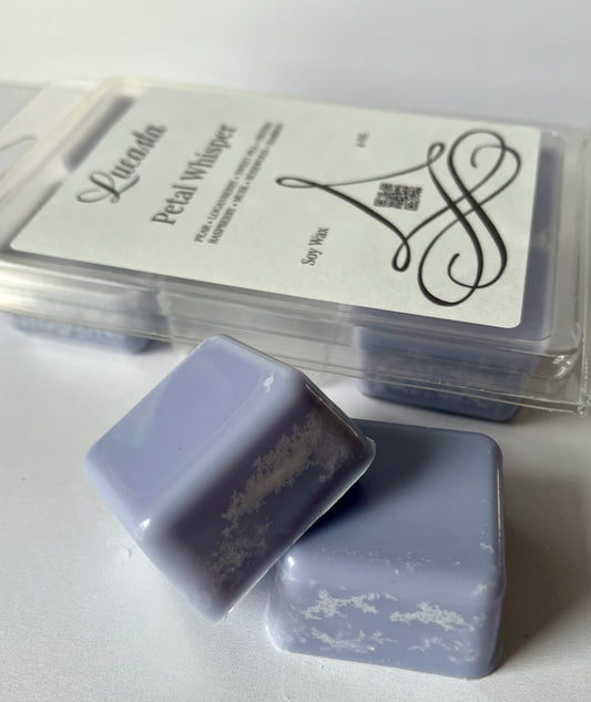 Two lavender-colored wax melts with a clear container labeled 'Lucasta' on a white background.