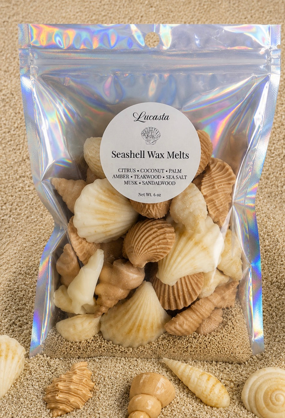 Lucasta Coastal Seashell Wax Melts in an iridescent holographic bag displayed on sandy beach with real seashells