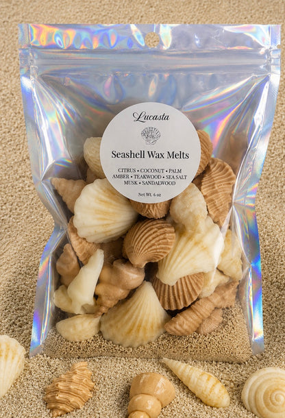 Lucasta Coastal Seashell Wax Melts in an iridescent holographic bag displayed on sandy beach with real seashells