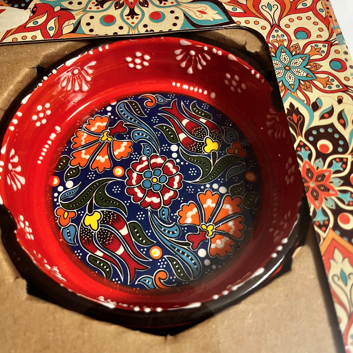 Orange hand-painted ceramic ashtray from Turkey with colorful floral design
