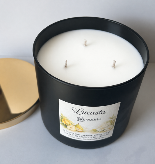 Black candle jar with three wicks and a label on a white background