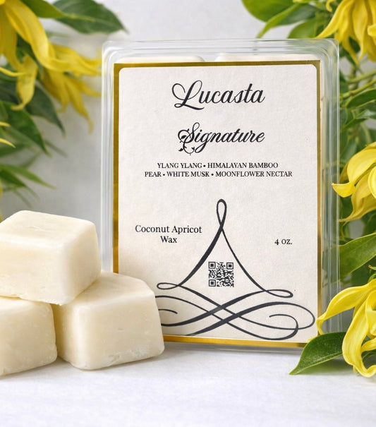 Lucasta Signature coconut apricot wax with packaging and yellow flowers in the background