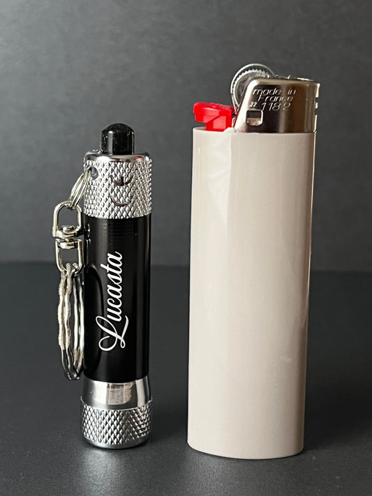 Lucasta flashlight next to standard lighter to show size