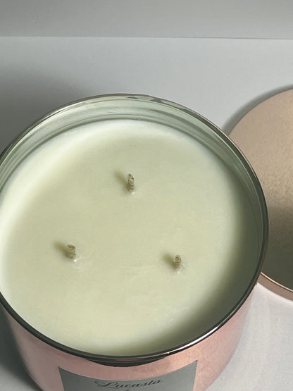 Lucasta Pure unscented 3-wick soy candle in rose gold jar showing wax surface, top-down view