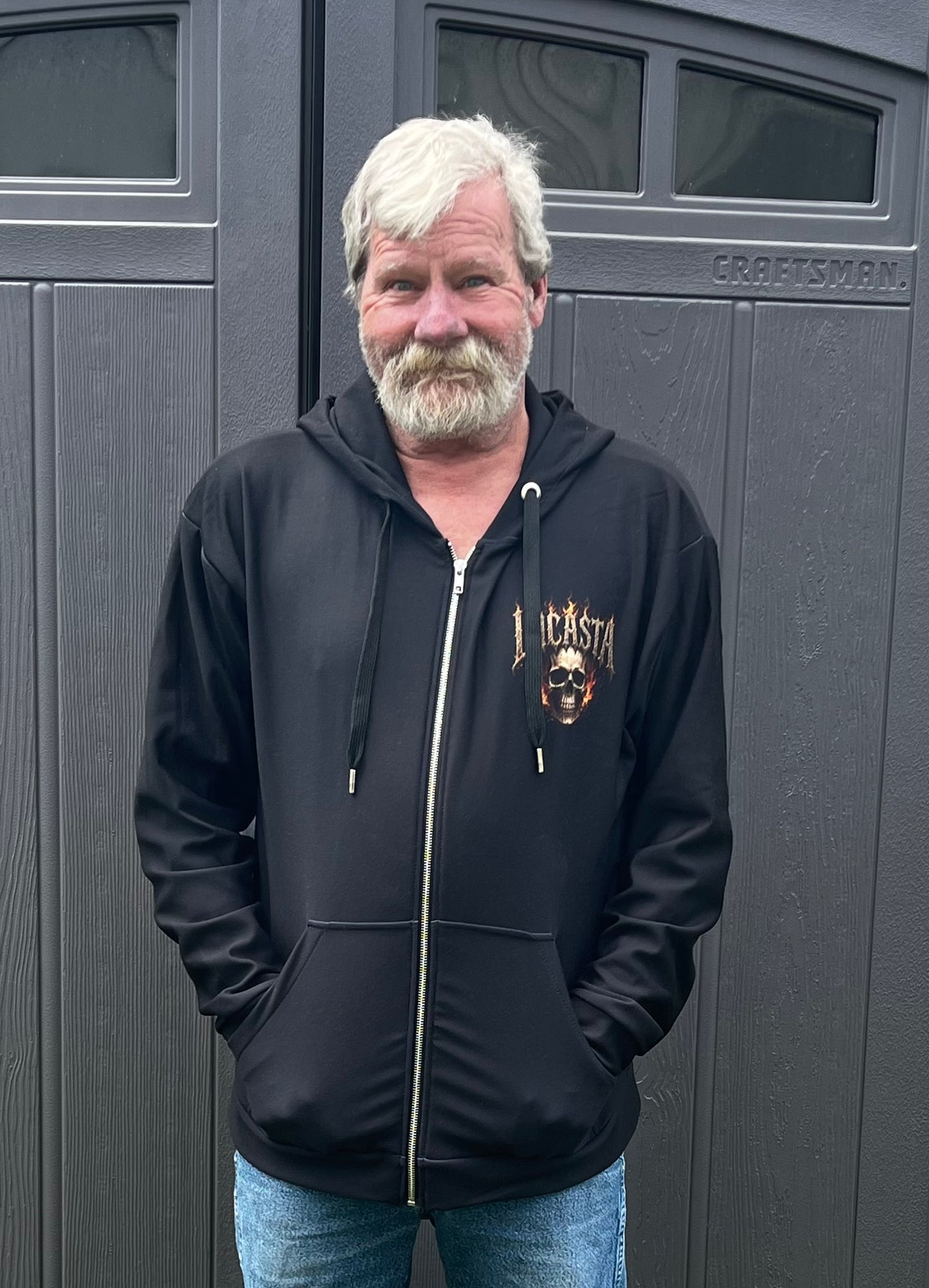 Man wearing Lucasta Inferno Zip Hoodie, front lifestyle shot showing skull design