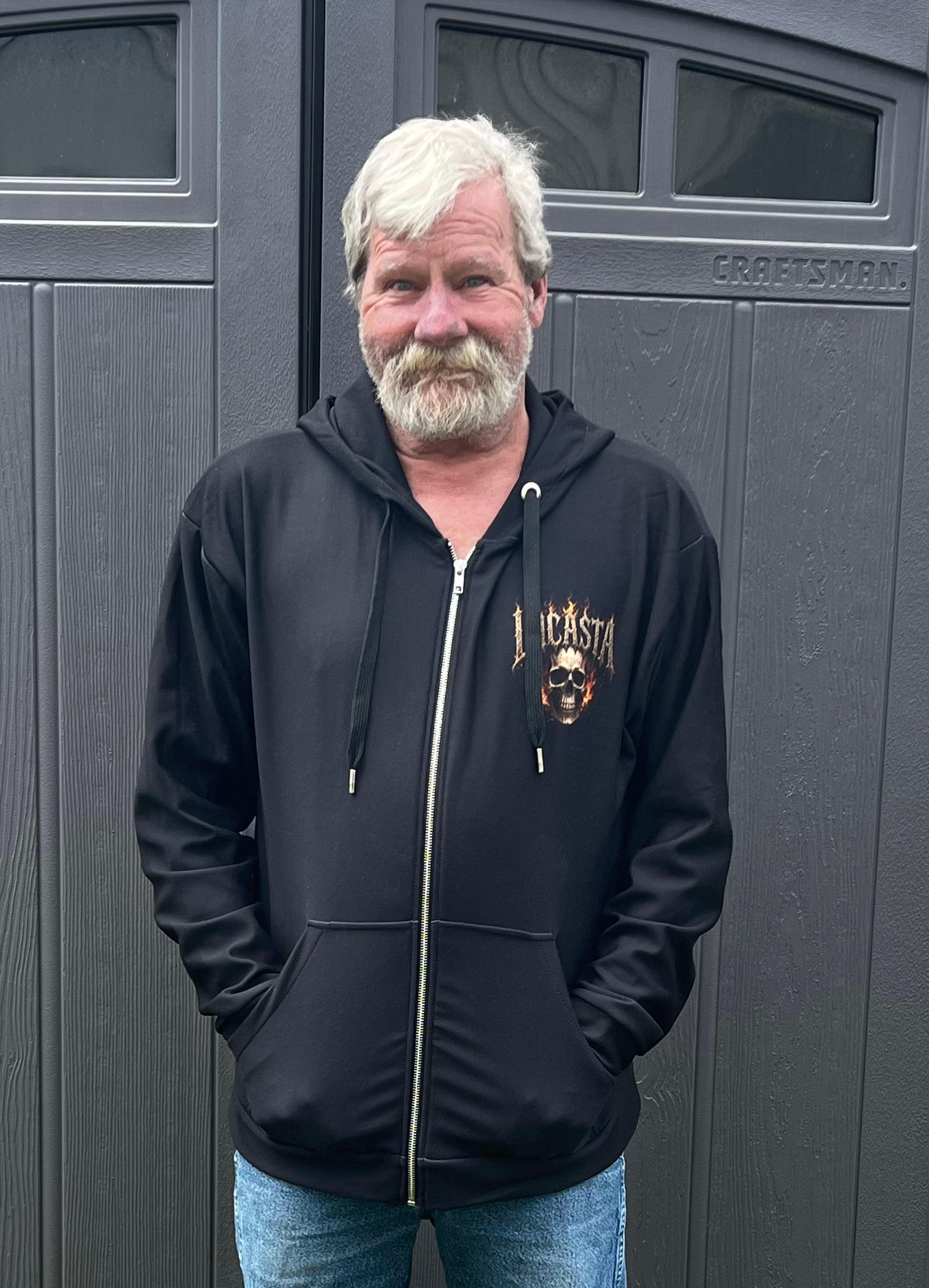 Man wearing Lucasta Inferno Zip Hoodie, front lifestyle shot showing skull design