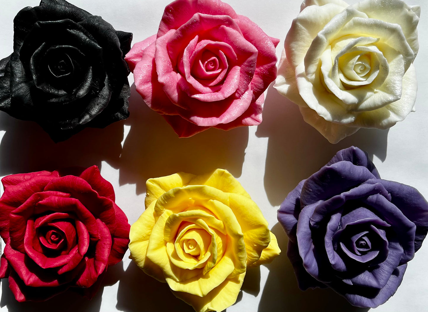The Rose Parlor collection — six hand-poured beeswax rose wax melts in black, pink, ivory, red, yellow, and violet