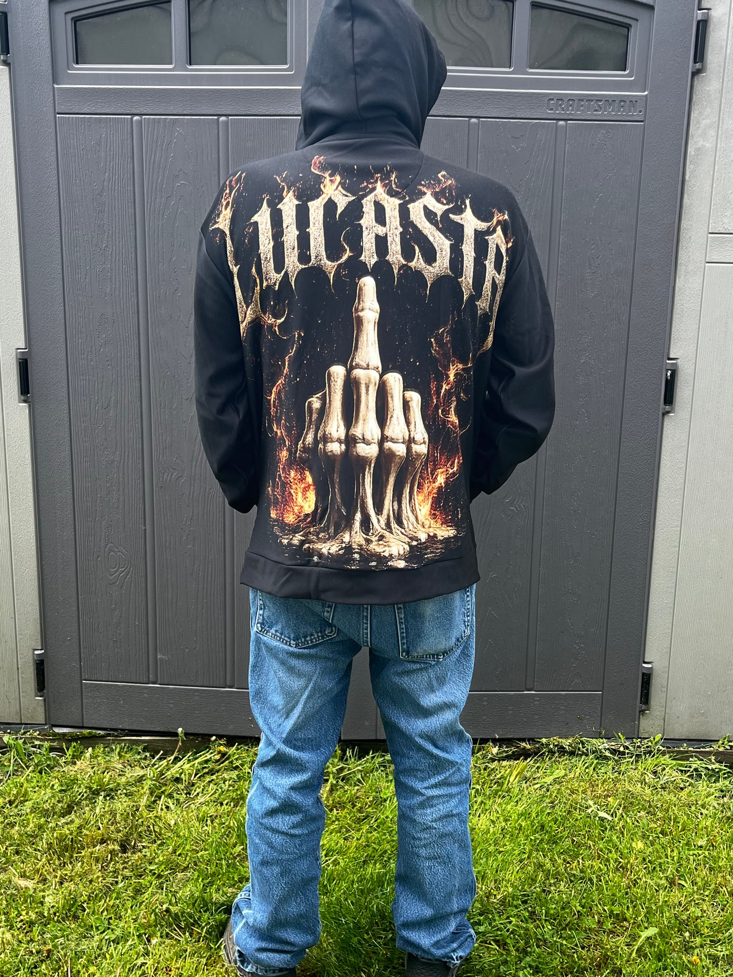 Person wearing Lucasta Inferno Zip Hoodie showing full skeleton graphic design, lifestyle shot