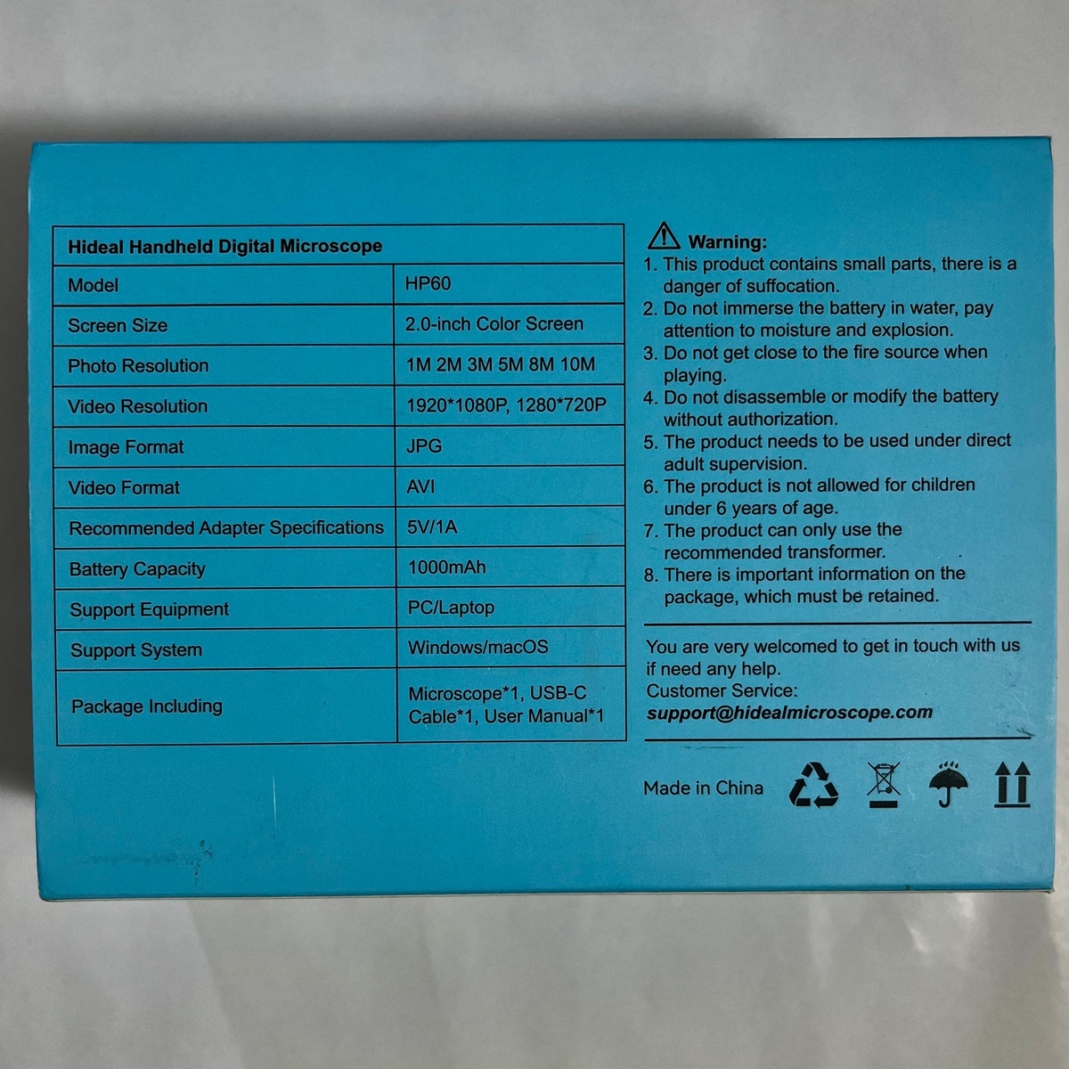 The back of a bright blue product box showing printed specifications and warnings for a HIDE handheld digital microscope, including model HP190, screen size, resolution, battery capacity, and package contents.