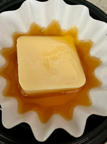 Lucasta Creamsicle wax melt melting in a wax warmer dish