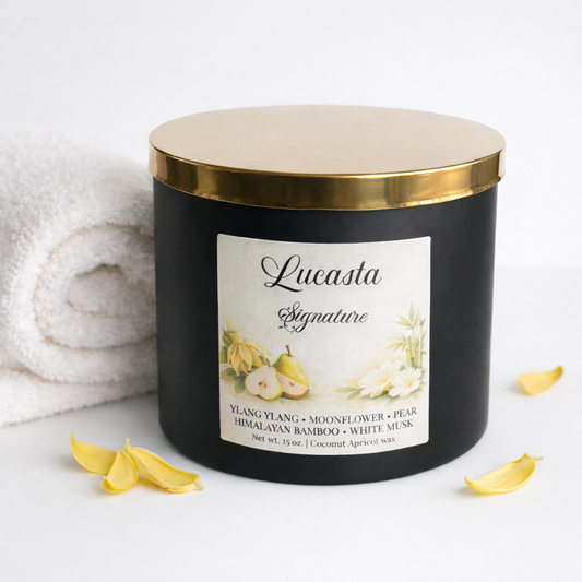 Black candle with gold lid and 'Lucasta' Signature label on a white background