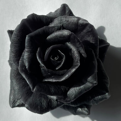 Black beeswax rose wax melt with a dark, glittering finish — hand-poured by Lucasta Candles