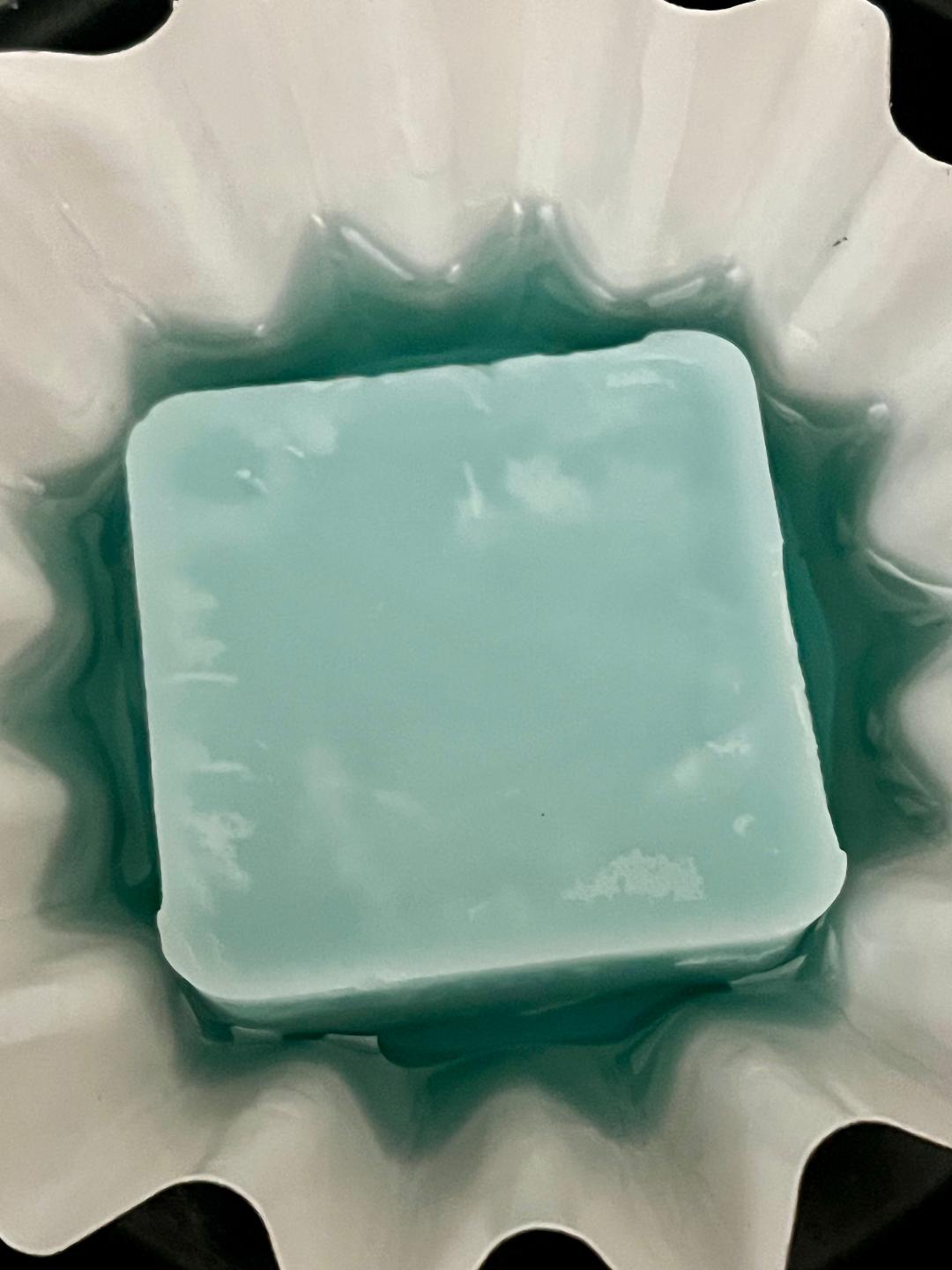 Lucasta Linen & Lace light blue wax melt melting in a decorative white warmer dish