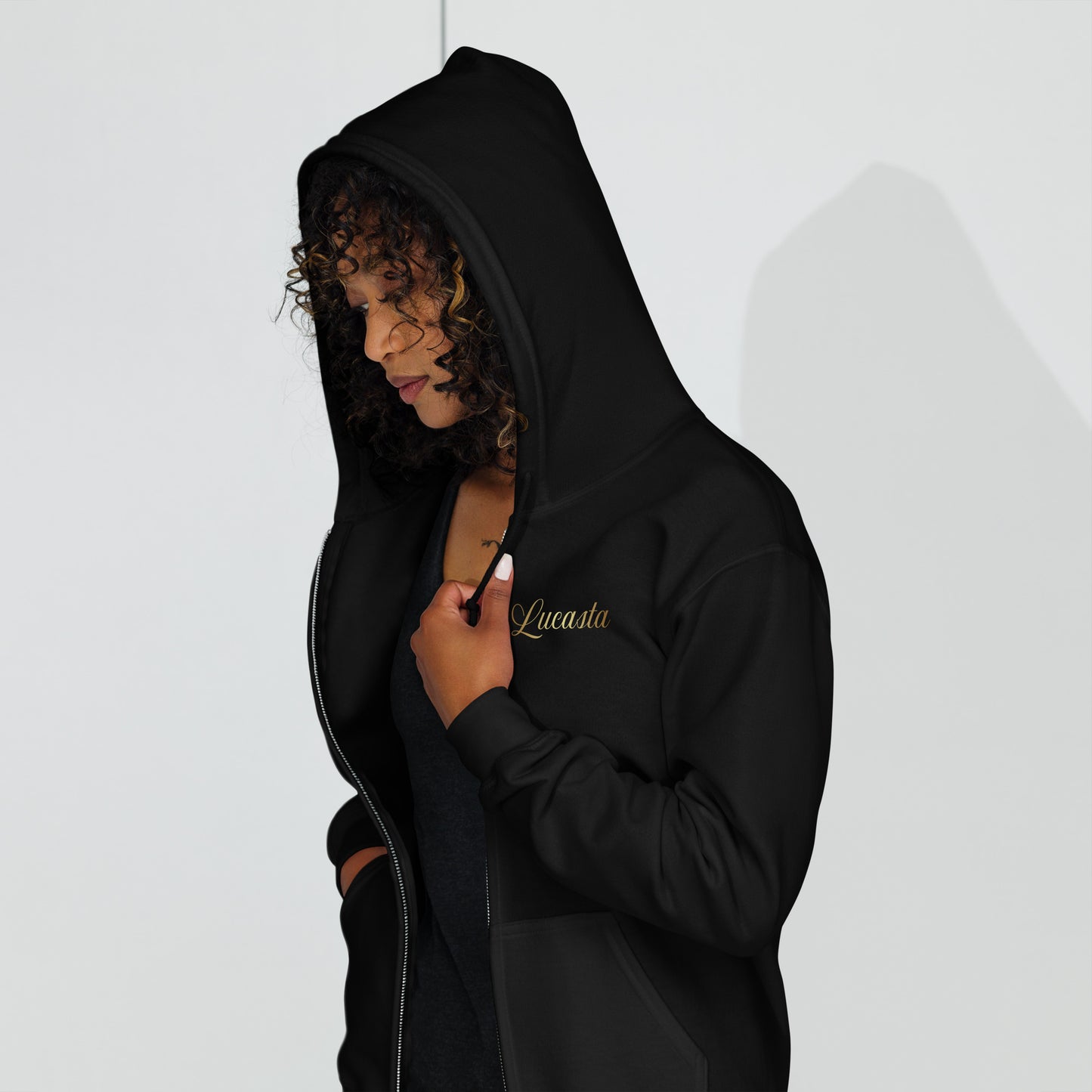 Woman wearing Lucasta Essentials black zip hoodie, front lifestyle shot